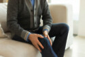 Man touching his knee