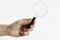 Person holding magnifying glass