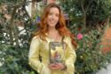 Samantha poses with VNCCII: The Awakening of a Divine Warrior which will go to the Moon in July. credit VNCCII